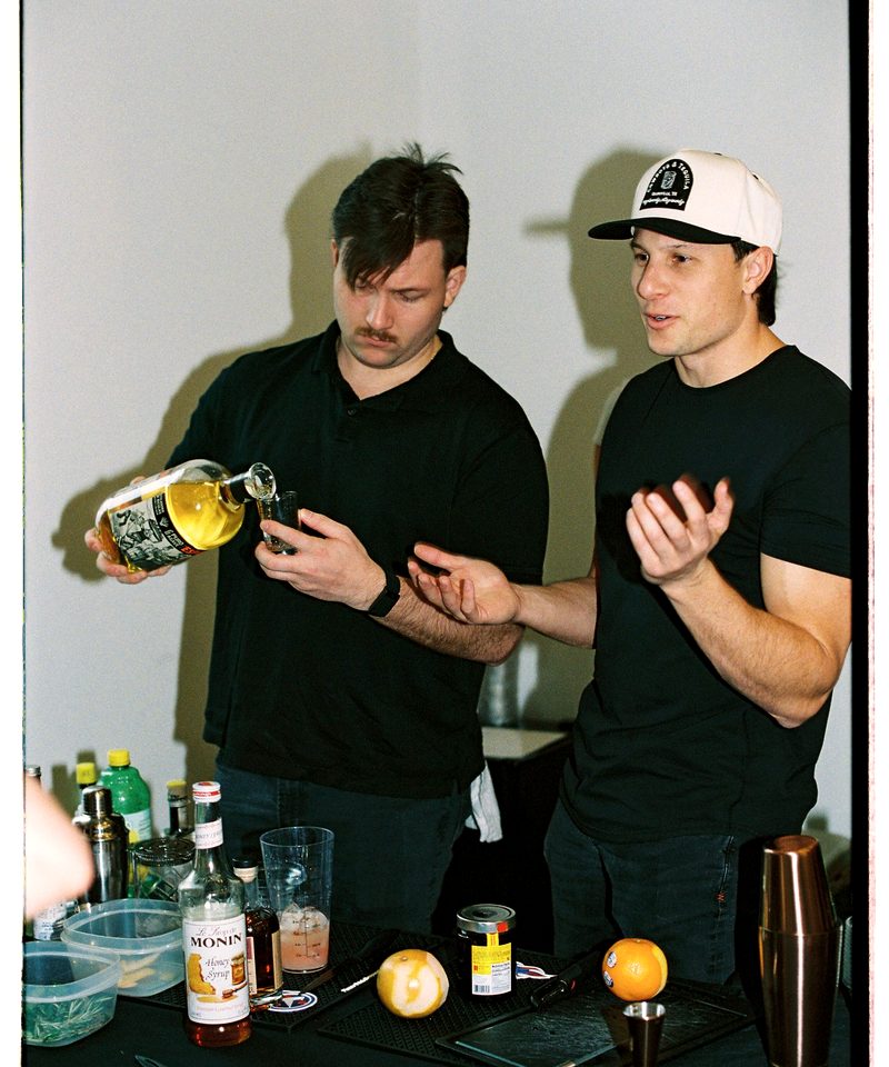 Evan and Connor, co-founders of Oak and Agave, crafting cocktails at the bar