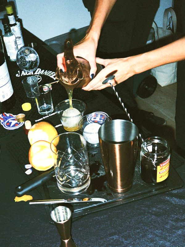 Bartender pouring a cocktail through a strainer