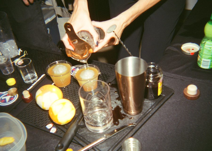 Straining cocktails into glasses at the mobile bar