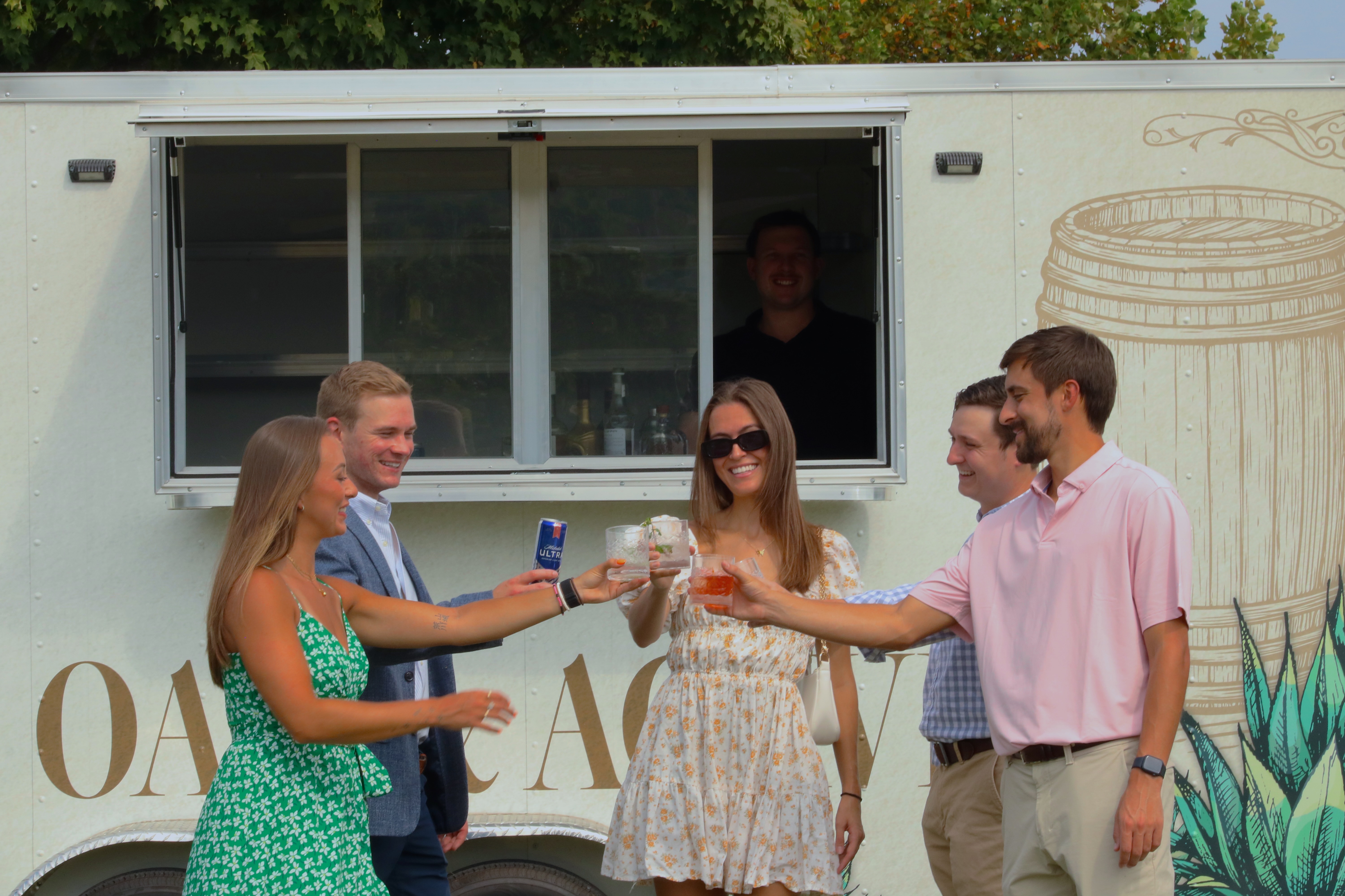 Friends toasting in front of trailer