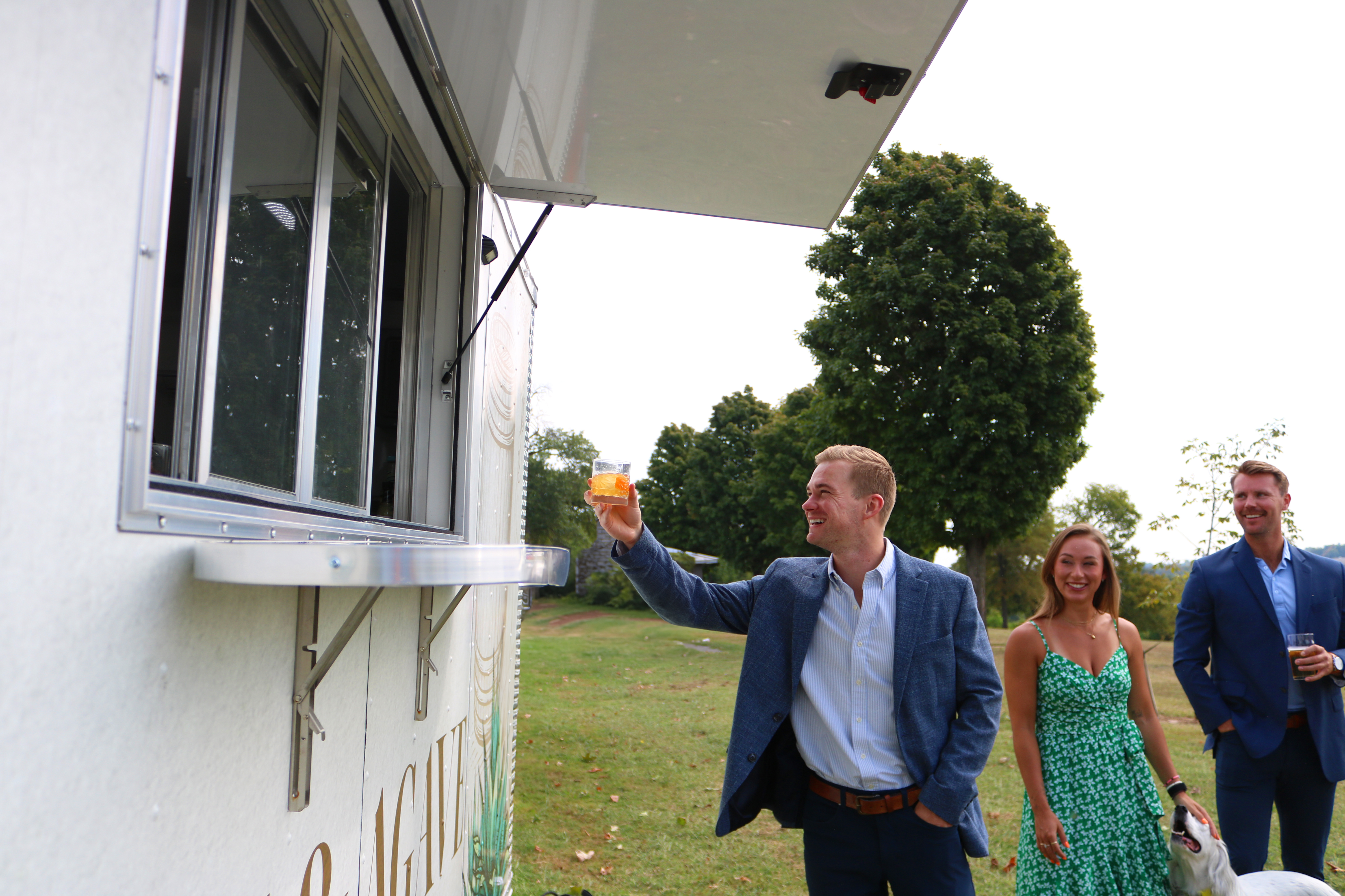 Guests getting drink from bar trailer